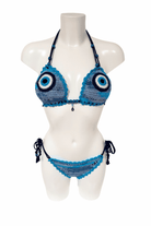 Blue evil eye luxury crochet bikini, designed and handmade in Switzerland by RA LIVING – exclusive designer beachwear and swimwear for a stylish summer look.